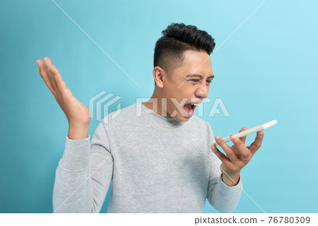 You will have problems man! Angry confused aggressive in bad mood guy shouting threatening in the loudspeaker of his smartphone 76780309