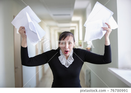 Office worker in stress. Uneven woman scatters paper. Office worker in stress. Uneven woman scatters paper. 76780991