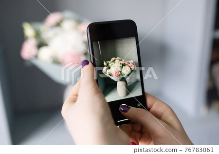 blogger takes a photo of a bouquet of flowers 76783061