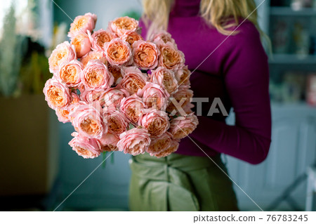 Large beautiful bouquet of mixed flowers in woman hand. Floral shop concept . Handsome fresh bouquet. Flowers delivery. Large beautiful bouquet of mixed flowers in woman hand. Floral shop concept . Handsome fresh bouquet. Flowers delivery. 76783245