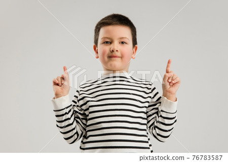 Caucasian boy isolated on white studio background. Copyspace. Childhood, education, emotions concept Caucasian boy isolated on white studio background. Copyspace. Childhood, education, emotions concept 76783587