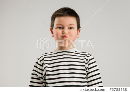 Caucasian boy isolated on white studio background. Copyspace. Childhood, education, emotions concept Caucasian boy isolated on white studio background. Copyspace. Childhood, education, emotions concept 76783588