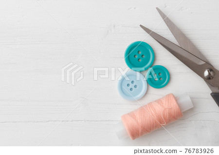 Colorful sewing accessories on white wooden table Colorful sewing accessories on white wooden table 76783926