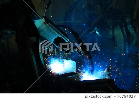 Robot arm in smart factory background. Mixed media of welding robot in the automotive parts industry 76784027