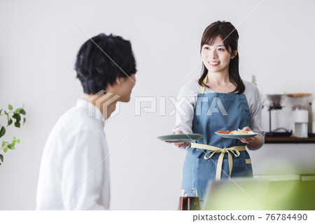 Wife carrying breakfast to her husband in telework Wife carrying breakfast to her husband in telework 76784490