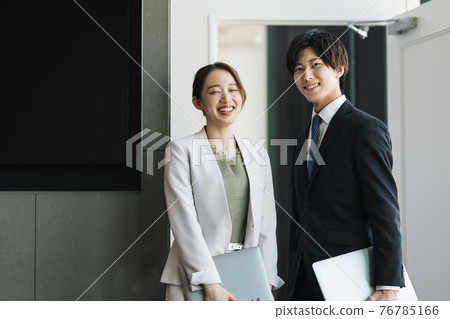 Young male and female business person portrait 76785166