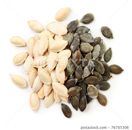 Pumpkin seeds or pepitas peeled and not peeled on a white background, isolated. The view from top Pumpkin seeds or pepitas peeled and not peeled on a white background, isolated. The view from top 76785306