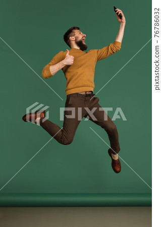 Caucasian man's portrait isolated over green studio background with copyspace 76786032