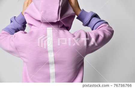 Child in sportive suit put on hood standing back Child in sportive suit put on hood standing back 76786766