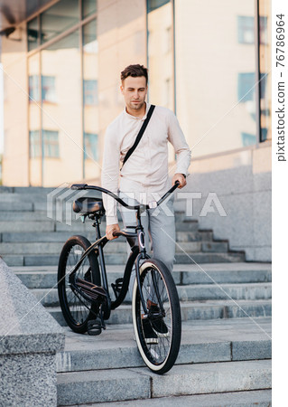 Manager on way to work in urban and eco transport, healthy lifestyle in morning 76786964