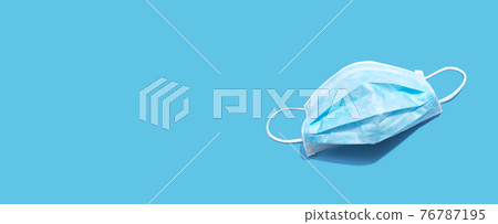 Blue surgical mask overhead view 76787195