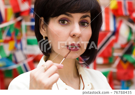 Brunette woman sexy holding glasses near lips 76788435