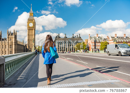 London city urban lifestyle tourist woman walking. Businesswoman commuting going to work on Westminster bridge street early morning. Europe travel destination, England, Great Britain, UK 76788867