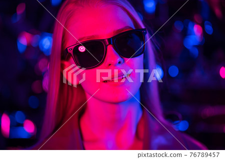 Young blond woman in sunglasses in a nightclub. Young blond woman in sunglasses in a nightclub. 76789457