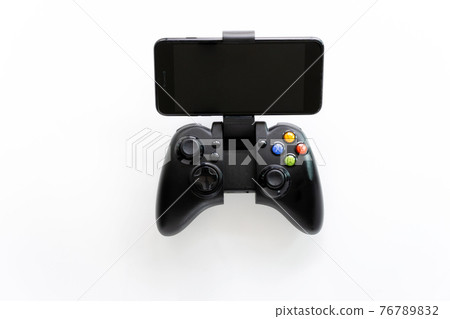 A Black gaming joystick with smartphone installed into holder, with blank black screen, turned off. Isolated on white background 76789832