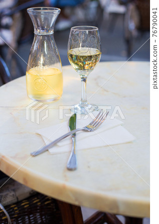 White wine in a liter bottle on a table in a cafe 76790041