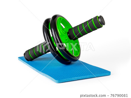Ab wheel on blue knee pad Isolated on white background. Ab trainer for abdominal muscles. 76790081