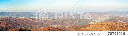 Mountain wilderness landscape, panorama forest-covered mountain range hills, nature Carpathians Ukraine, warm autumn day October. 76791026