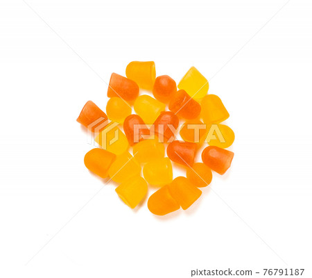 Close-up texture of orange and yellow multivitamin gummies on white background. Healthy lifestyle concept. Close-up texture of orange and yellow multivitamin gummies on white background. Healthy lifestyle concept. 76791187