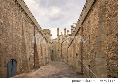 The walls and towers of the old palace on the background of a cloudy sky The walls and towers of the old palace on the background of a cloudy sky 76791447