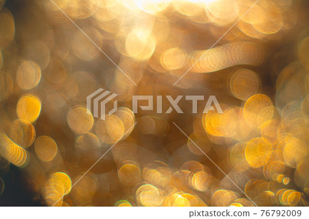 Golden streamers with sparkling glitter. Christmas holidays background 76792009