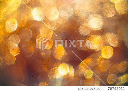 Golden streamers with sparkling glitter. Christmas holidays background 76792011