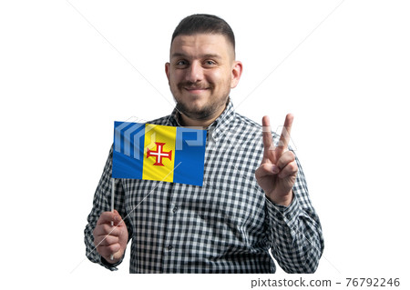 White guy holding a flag of Madeira and shows two fingers isolated on a white background White guy holding a flag of Madeira and shows two fingers isolated on a white background 76792246