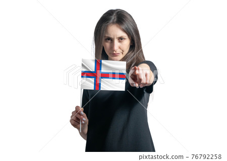 Happy young white woman holding flag of Faroe Islands and points forward in front of him isolated on a white background Happy young white woman holding flag of Faroe Islands and points forward in front of him isolated on a white background 76792258