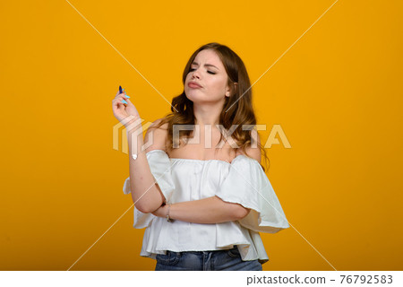 Cheerful young female in formal wear holding pen and smiling Cheerful young female in formal wear holding pen and smiling 76792583