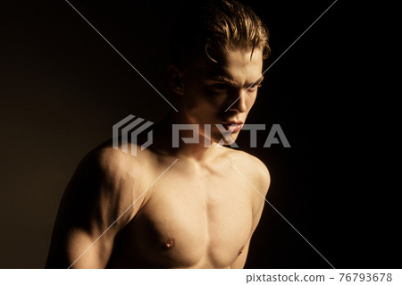 Muscle strong beautiful stripped male model in black jeans on black isolated font background Muscle strong beautiful stripped male model in black jeans on black isolated font background 76793678
