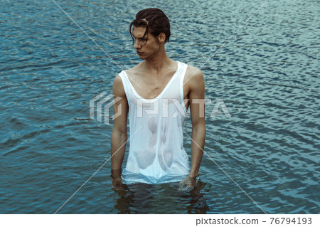 Sexy beauty male model lying stripped on the sand with nature background Sexy beauty male model lying stripped on the sand with nature background 76794193
