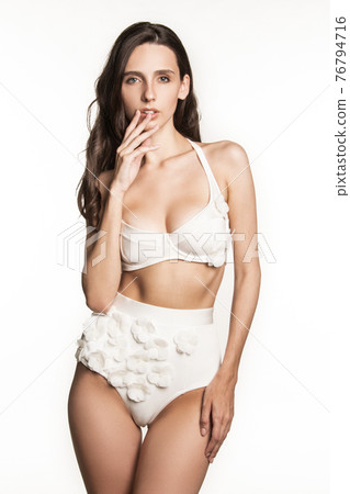 Stunning beautiful dark hair girl stripped in lingerie on white isolated font background Stunning beautiful dark hair girl stripped in lingerie on white isolated font background 76794716