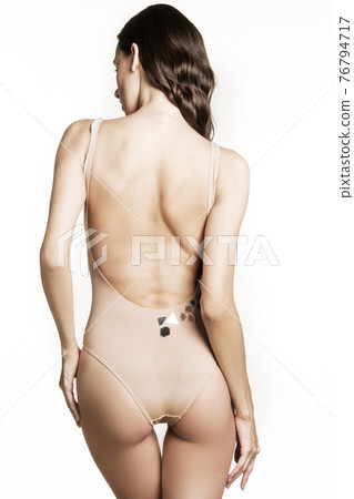 Stunning beautiful dark hair girl stripped in lingerie on white isolated font background 76794717
