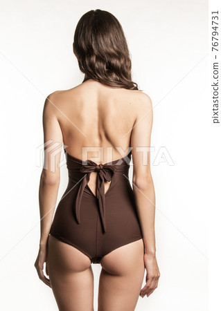 Stunning beautiful dark hair girl stripped in lingerie on white isolated font background 76794731