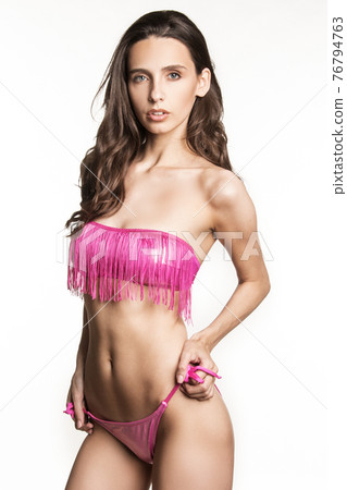 Stunning beautiful dark hair girl stripped in lingerie on white isolated font background Stunning beautiful dark hair girl stripped in lingerie on white isolated font background 76794763