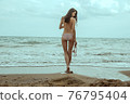 Stunning beautiful dark hair girl stripped in swimsuit on the sunset at he beach 76795404