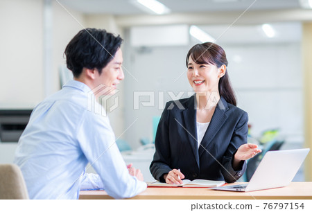 Young man consulting a business woman 76797154