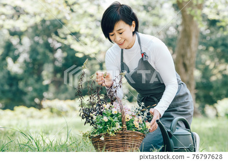 Japanese women doing flower care, group planting, and gardening 76797628