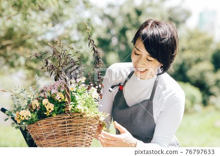 Japanese women doing flower care, group planting, and gardening 76797633