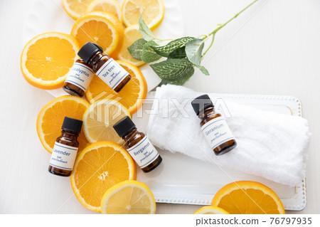 Aroma oil bottle and fruit (orange and lemon) Aroma oil bottle and fruit (orange and lemon) 76797935