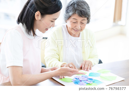 Caregiver image Origami senior woman and caregiver Caregiver image Origami senior woman and caregiver 76798377