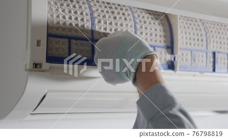 Hand of technician man working pulling dusty filter from air conditioner Hand of technician man working pulling dusty filter from air conditioner 76798819