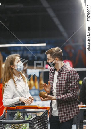 People in a medical mask in a supermarket 76799093