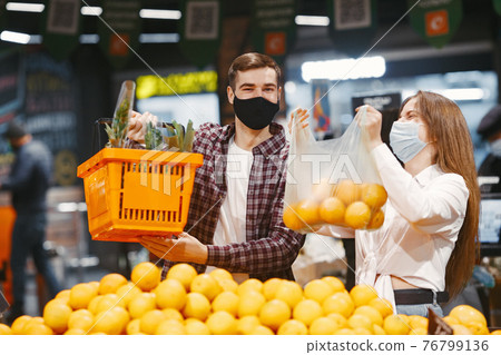 People in a medical mask in a supermarket People in a medical mask in a supermarket 76799136