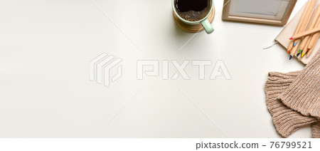 Top view of simple workspace with cup. frame, coloured pencils, sweater and copy space Top view of simple workspace with cup. frame, coloured pencils, sweater and copy space 76799521