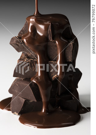 Sprinkle melted chocolate on a white background Sprinkle melted chocolate on a white background 76799872