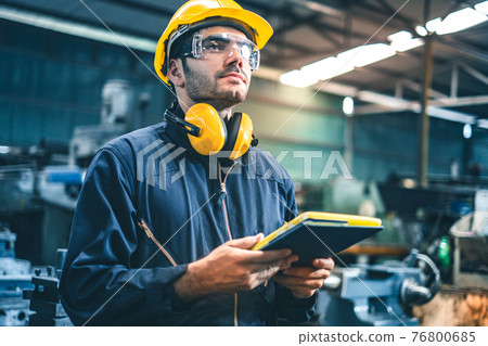 Industrial Engineers in Hard Hats.Work at the Heavy Industry Manufacturing Factory.industrial worker indoors in factory. man working in an industrial factory.Safety first concept. 76800685