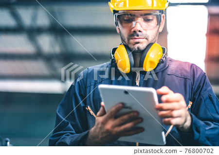 Industrial Engineers in Hard Hats.Work at the Heavy Industry Manufacturing Factory.industrial worker indoors in factory. man working in an industrial factory.Safety first concept. Industrial Engineers in Hard Hats.Work at the Heavy Industry Manufacturing Factory.industrial worker indoors in factory. man working in an industrial factory.Safety first concept. 76800702