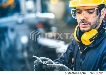 Industrial Engineers in Hard Hats.Work at the Heavy Industry Manufacturing Factory.industrial worker indoors in factory. man working in an industrial factory.Safety first concept. 76800704