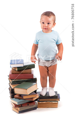 Boy stands on stack of books for educational portrait - isolated over white background Boy stands on stack of books for educational portrait - isolated over white background 76800758
